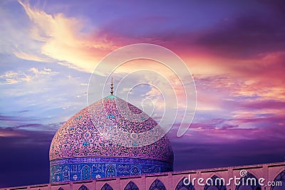 Fragment of traditional Iranian architecture against beatiful purple sky and yellow and pink clouds. Beautiful sunset. Stock Photo