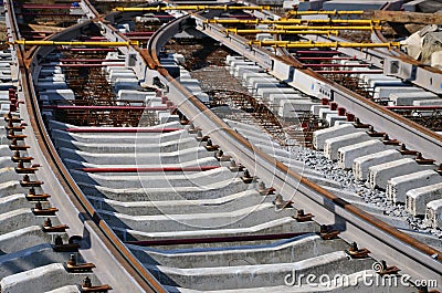 Fragment of tram rails at the stage of their installation and integration into the road. The process of laying a tramwa Stock Photo