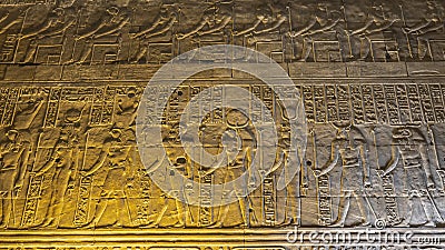 A fragment of the wall of an ancient Egyptian temple in Kom Ombo Editorial Stock Photo