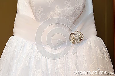 Fragment of a wedding dress in front close up Stock Photo