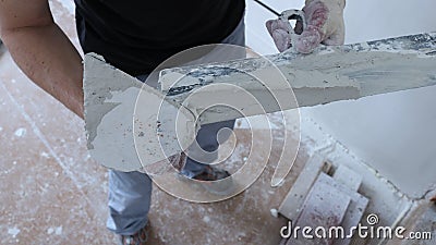 Plasterer with construction tools and elastic mortar Stock Photo