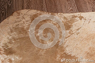 A fragment of a worn beige hide laid on the laminate Stock Photo