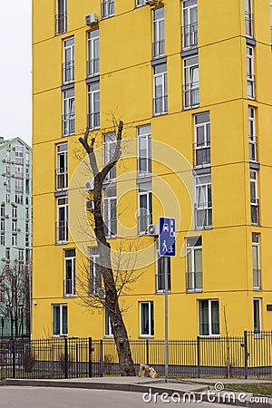 Fragment of yellow facade of multi story apartment building Stock Photo