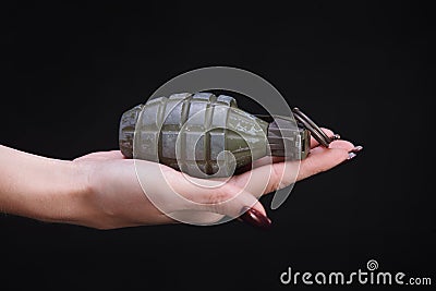 fragmentation grenade in woman hand Stock Photo