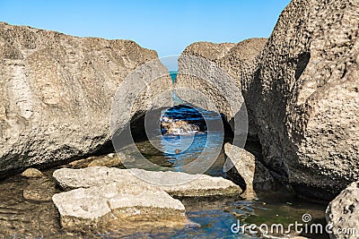 Fragments of ancient rocks on sea coast Stock Photo