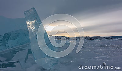 Fragments of ice are scattered over the surface of the frozen lake. Stock Photo