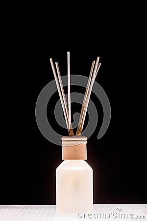 Fragrance for home. Aroma diffuser glass jar with aromatic liquid and bamboo sticks Stock Photo