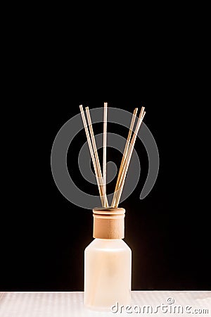 Fragrance for home. Aroma diffuser glass jar with aromatic liquid and bamboo sticks Stock Photo