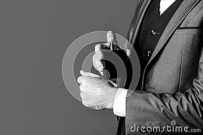 Fragrance smell. Men perfumes. Fashion cologne bottle. Man holding up bottle of perfume. Men perfume in the hand on suit Stock Photo