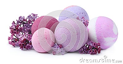 Fragrant bath bombs and lilac flowers on white background Stock Photo