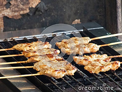 fragrant smoke wafted through the air as the grilled pork skewers sizzled on the hot grill, their tantalizing aroma captivating Stock Photo