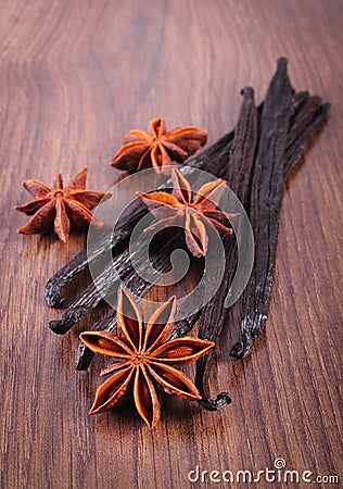 Fragrant vanilla and star anise on wooden surface plank Stock Photo