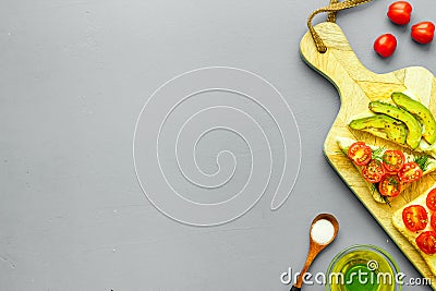 Frame of avocado sandwiches on grey kitchen table top view copy space Stock Photo
