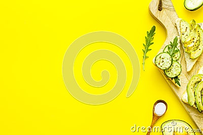 Frame of avocado sandwiches on yellow kitchen table top view copy space Stock Photo