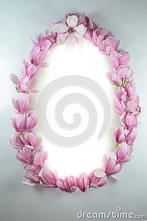 Frame made of magnolia flowers on a white board Stock Photo