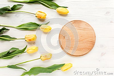 Frame with beautiful yellow tulips isolated on a white, wooden background. lay flat, top view Stock Photo