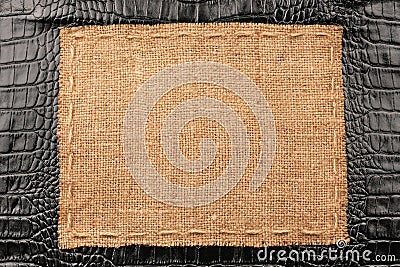 Frame of burlap, lies on a background of black leather Stock Photo