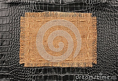 Frame of burlap, lies on a background of black leather Stock Photo