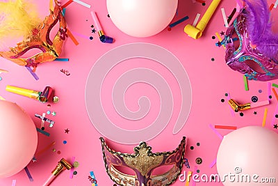 Frame of carnival masks and party decor on pink background, flat lay. Space for text Stock Photo