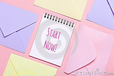 Frame from colorful envelopes and notepad on pink table top view. Stock Photo