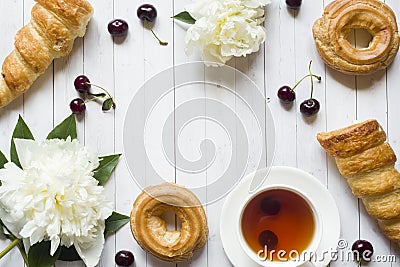 Frame custard cakes cherry flowers peony tea Cup. Copy space Stock Photo