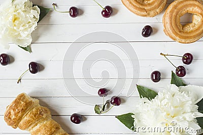 Frame custard cakes cherry peony flowers. Copy space Flat lay Stock Photo