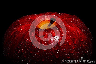 A Frame filling Macro image of a vibrant Red apple covered in water drops beading on the peel. Featuring 1/3 frame of negative Stock Photo