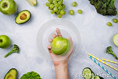 Frame flatlay with various green fruits and vegetables: lettuce, cucumber, avocado, broccoli, grapes, apples etc Stock Photo
