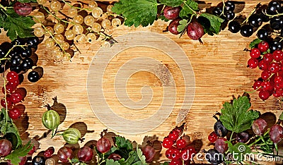 A frame of garden berries on a wooden board. Stock Photo