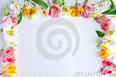 Frame for greeting card with flowers. Banner with natural astromeria flowers on a wooden background. Frame for text with flowers Stock Photo