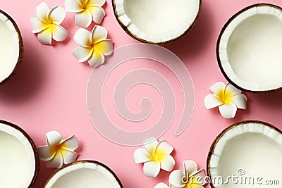 Frame made of fresh coconut halves and flowers on pink background, flat lay. Space for Stock Photo