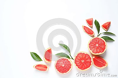 Frame made of grapefruits and leaves on white background, top view. Citrus fruits Stock Photo