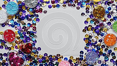 Frame of many different shiny colorful sequins on light grey background, flat lay. Space for text Stock Photo