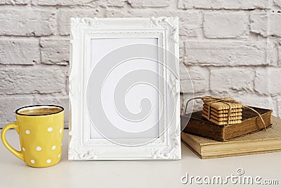 Frame Mockup. White Frame Mock Up. Yellow Cup Of Coffee With White Dots, Cappuccino, Latte, Old Books, Cookies. Display Mock-Up, Stock Photo