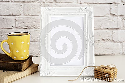 Frame Mockup. White Frame Mock Up. Yellow Cup Of Coffee With White Dots, Cappuccino, Latte, Old Books, Cookies. Display Mock-Up Stock Photo