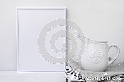 Frame mockup, white vintage pitcher on stack of linen towels, minimalist clean styled image Stock Photo