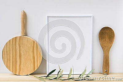 Frame mockup, wood cutting board, spoon, olive tree branch on white background, styled image Stock Photo