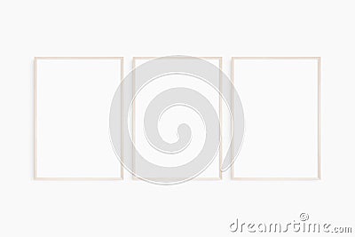 Frame mockup 5x7, 50x70, A4, A3, A2, A1. Set of three thin light wood frames. Gallery wall mockup, set of 3 frames. Stock Photo