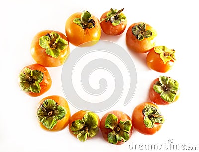 Frame. Persimmon with a leaf, a circle on a white background. Ripe fruit. Color photo Stock Photo