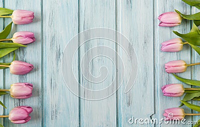 Frame with pink tulip flowers and wooden background, copy space Stock Photo