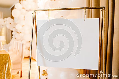 Frame. Place for text. White paper in gold frame. Easel. Luxury style elegant wedding decor for the ceremony Stock Photo