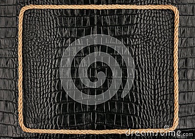 Frame of rope, lies on a background of a black crocodile leathe Stock Photo