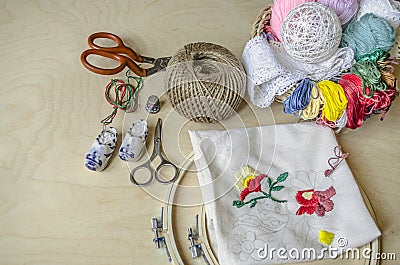 Frame, scissors, colored threads and needles necessary tools Stock Photo