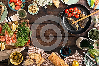 Frame of shrimp, fish grilled, salad, snacks and white wine Stock Photo