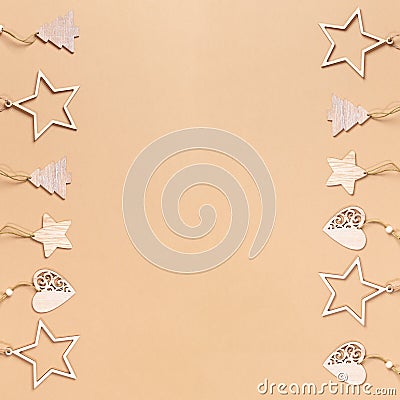 Frame of two vertical rows of Christmas festive craft decorations on beige background with copy space. Stock Photo