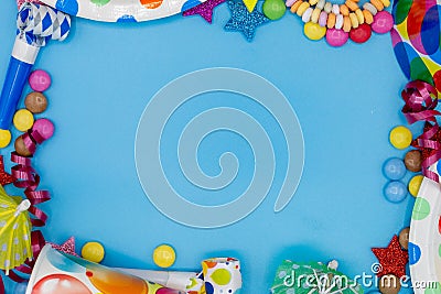 Frame of various sweets and utensils for children's birthdays or parties with blue background and copy space Stock Photo