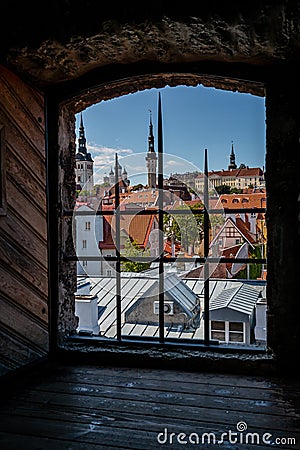 Framed cityscape view of Tallinn, Estonia looking through medieval tower stone Editorial Stock Photo