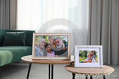 Framed family portraits in living room at home Stock Photo