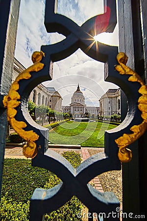 Framed view of courtyard and city hall through fancy black and golden gilded lamppost Stock Photo