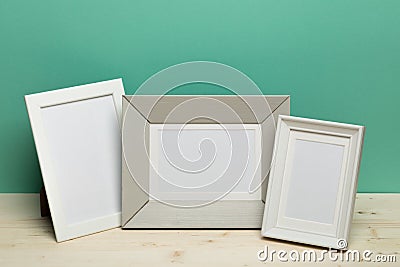 Frames on desk near green wall Stock Photo